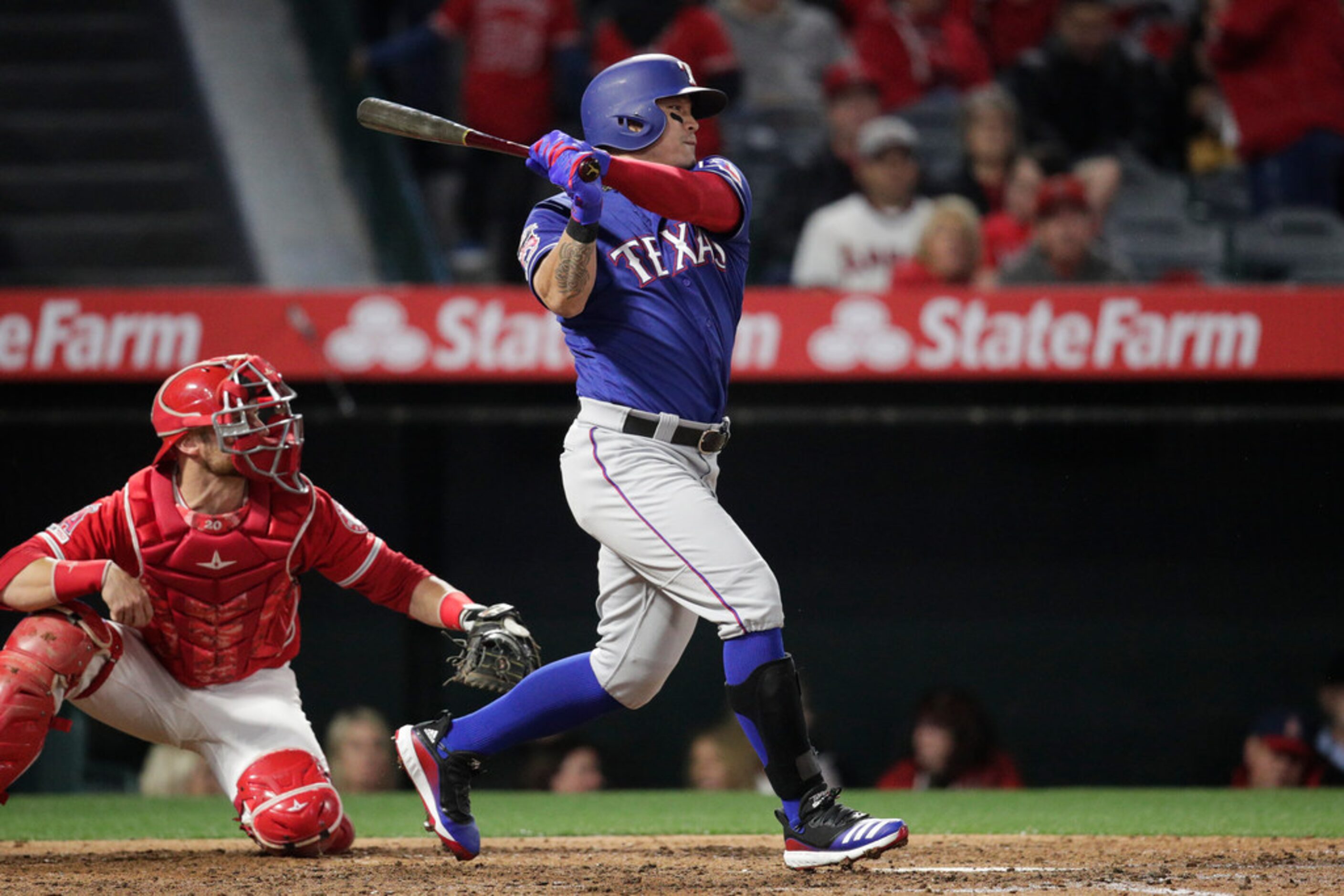 Texas Rangers' Shin-Soo Choo, of South Korea, watches his single during the fifth inning of...