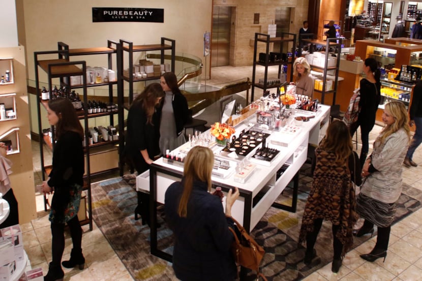 Kelly St. John (right), vice president of beauty for Neiman Marcus, talks to customers at...