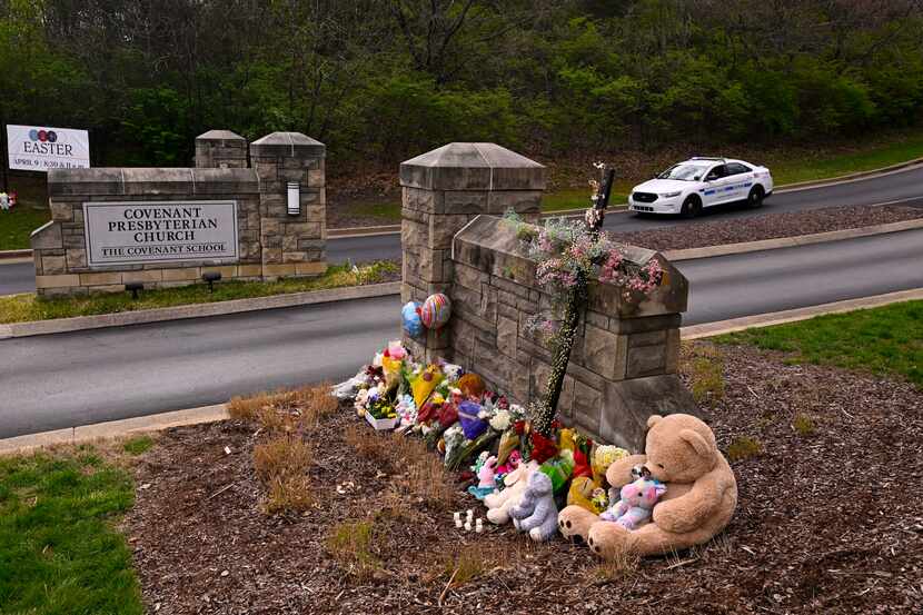 A makeshift memorial is seen at the entry to Covenant School with a police car guarding, on...