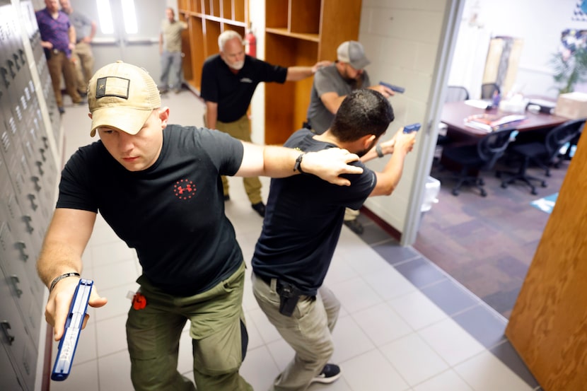 A four-man team (from front to back) led by Athens Police Officer Zachary Harris, Henderson...