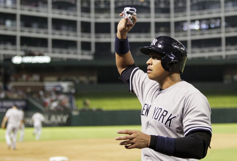 New York Yankees designated hitter Alex Rodriguez (13) tosses his glove in the stands after...