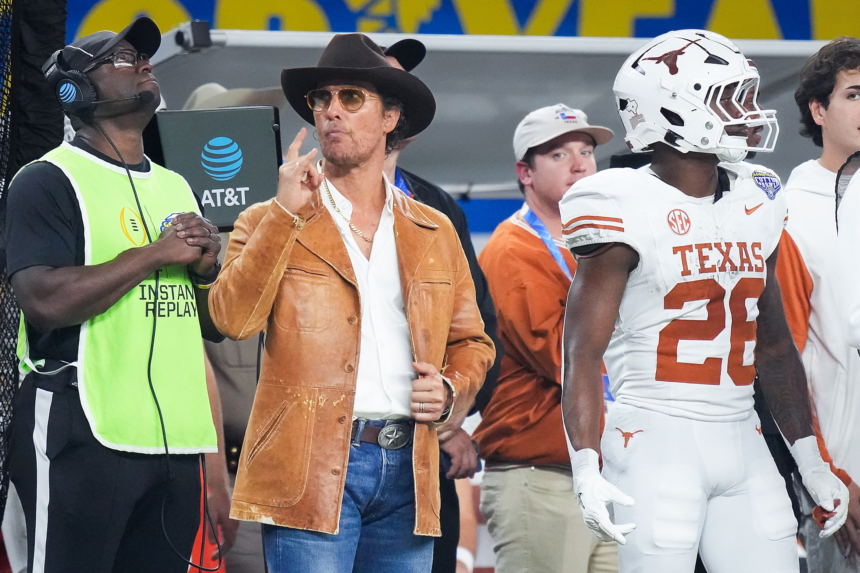 Actor Matthew McConaughey watches from the sideline next to running back Quintrevion Wisner...