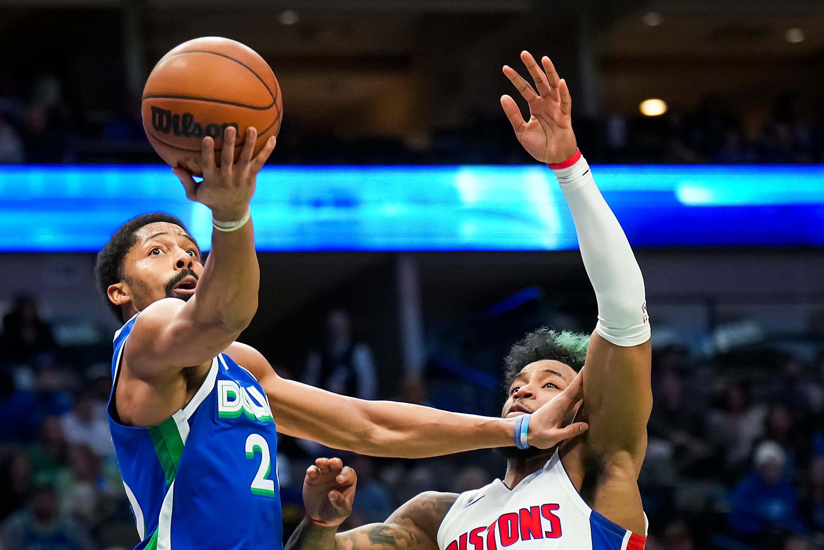 Dallas Mavericks guard Spencer Dinwiddie (26) scores past Detroit Pistons forward Saddiq Bey...