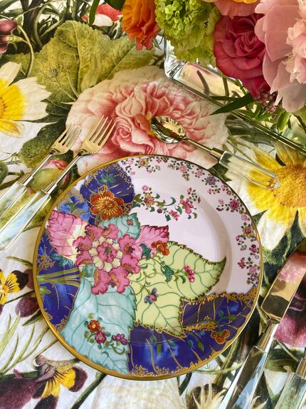 Colorful tobacco-leaf patterned tin dish on a floral table cloth