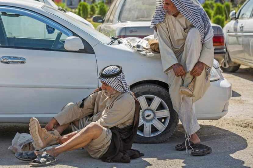
Iraqi volunteers put on their newly issued boots in Karbala, 50 miles south of Baghdad....