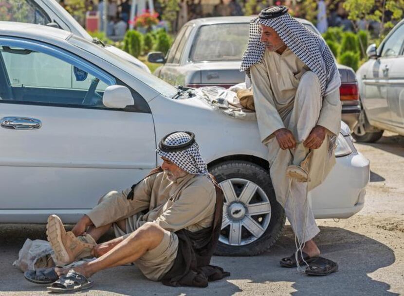 
Iraqi volunteers put on their newly issued boots in Karbala, 50 miles south of Baghdad....