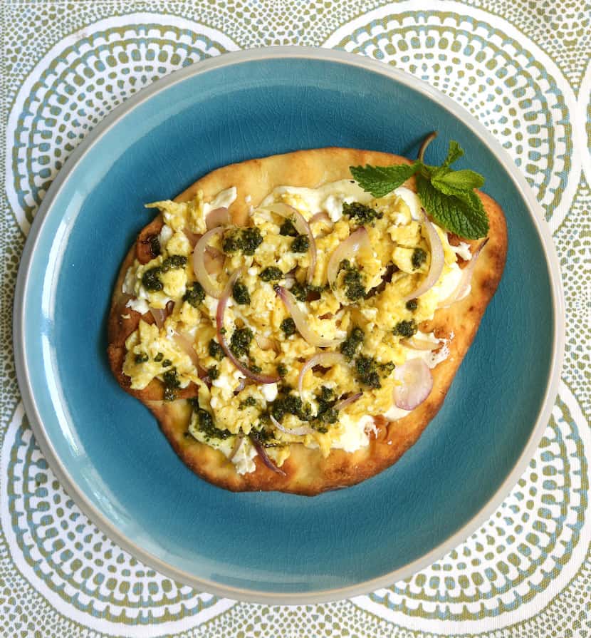 Breakfast flatbread with eggs, cheese, and parsley-mint pesto