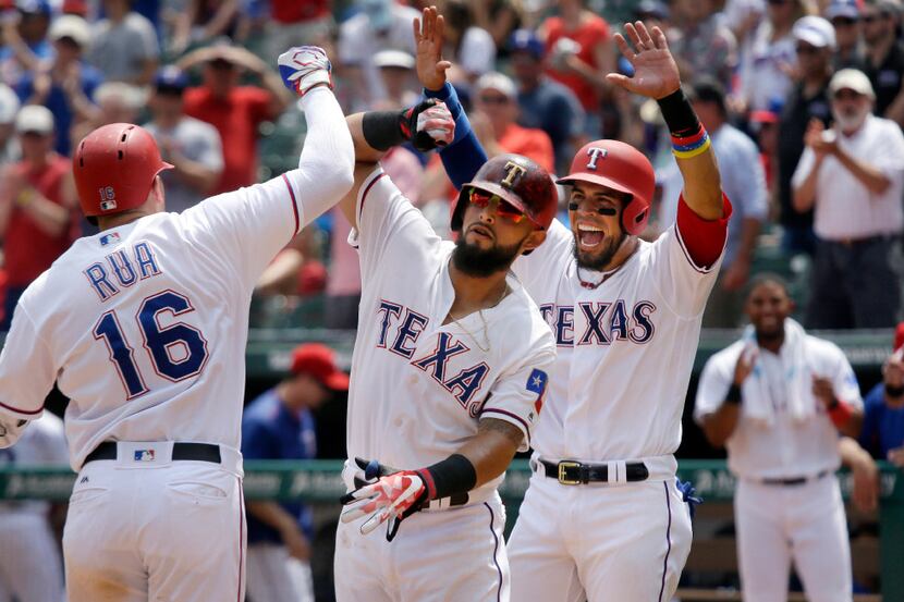Texas Rangers Ryan Rua (16) celebrates his 3-run homer with teammates Rougned Odor, center,...