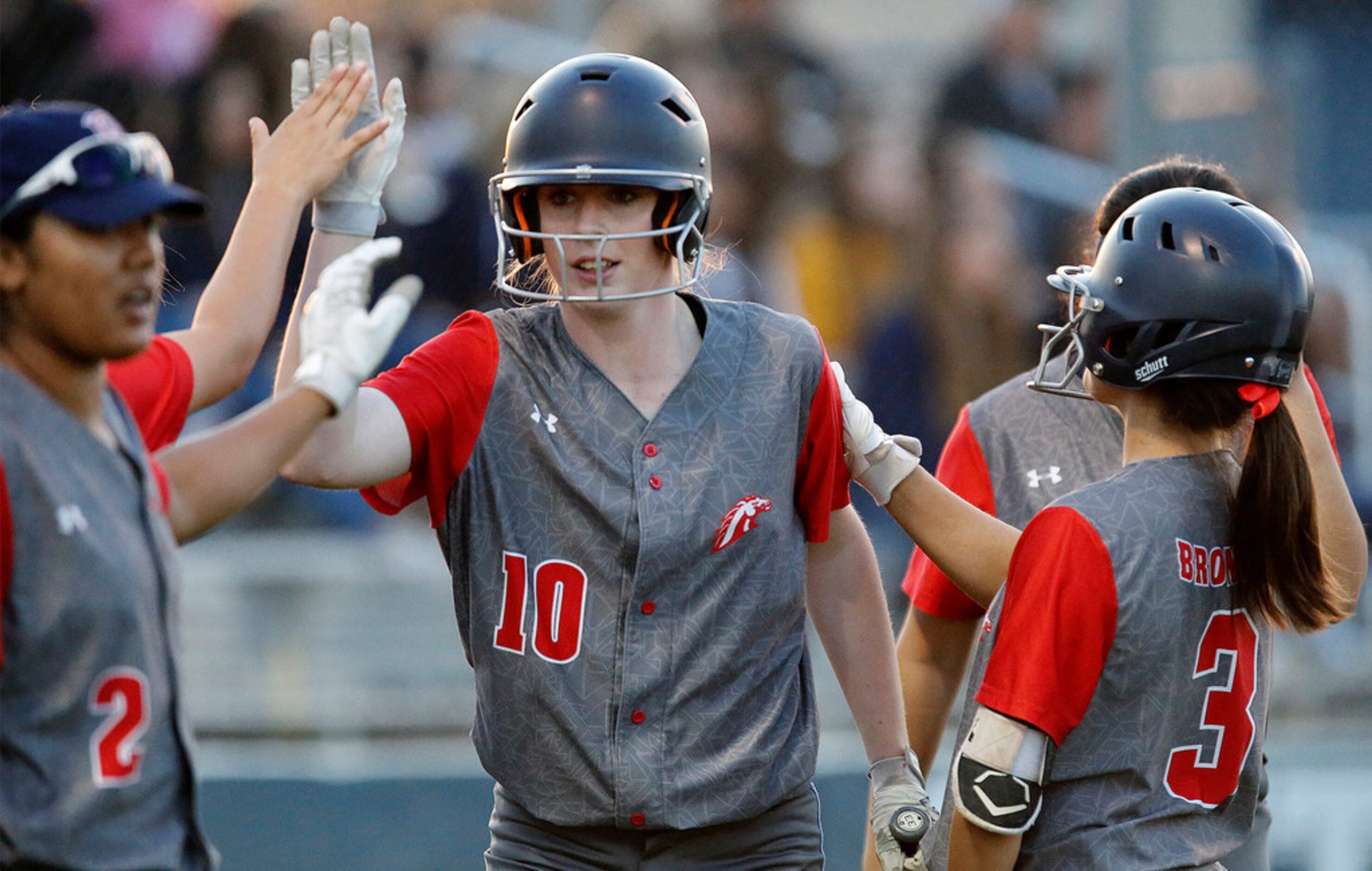 McKinney Boyd High School pitcher Kinsey Kackley (10) is greeted by team mates after...