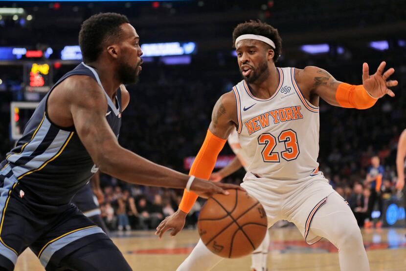 New York Knicks' Wesley Matthews, right, defends during the first half of the NBA basketball...