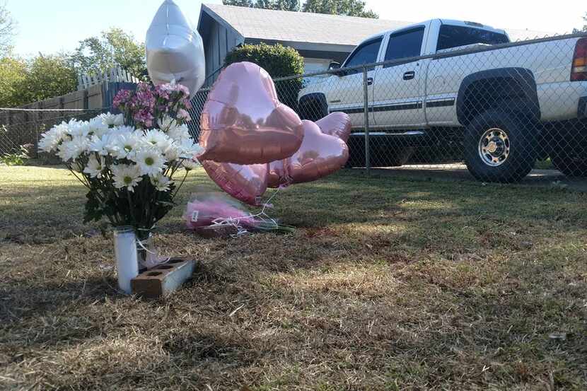 A memorial outside a Cedar Hill home where a woman was shot and killed and two other people...