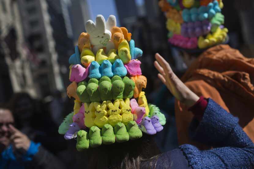 NEW YORK, NY - APRIL 5: A woman steadies her hat made of marshmallow peeps as she makes her...