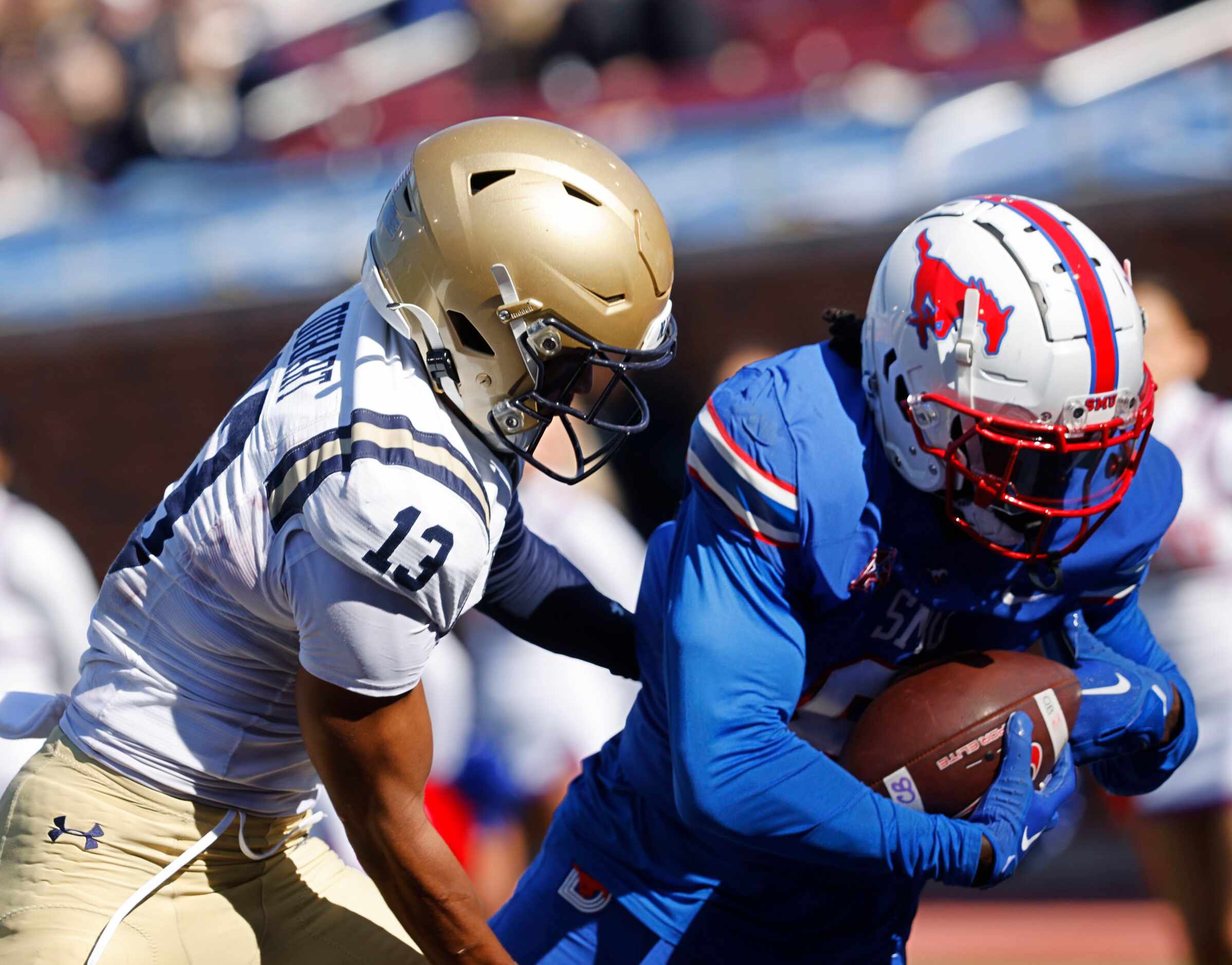 SMU wide receiver Jordan Hudson (8) catches a pass under pressure from Navy cornerback...