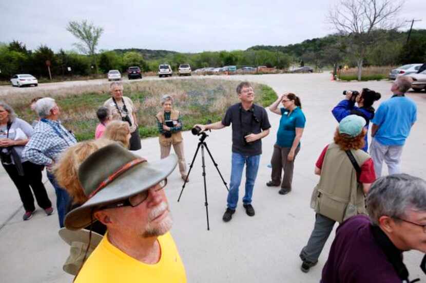 
David Sibley, with hand on tripod, speaks about North Texas birds during a bird watching...