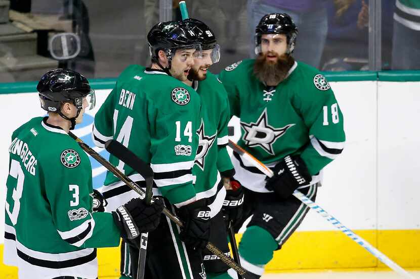 Dallas Stars left wing Jamie Benn (14) is congratulated for his goal by defenseman John...