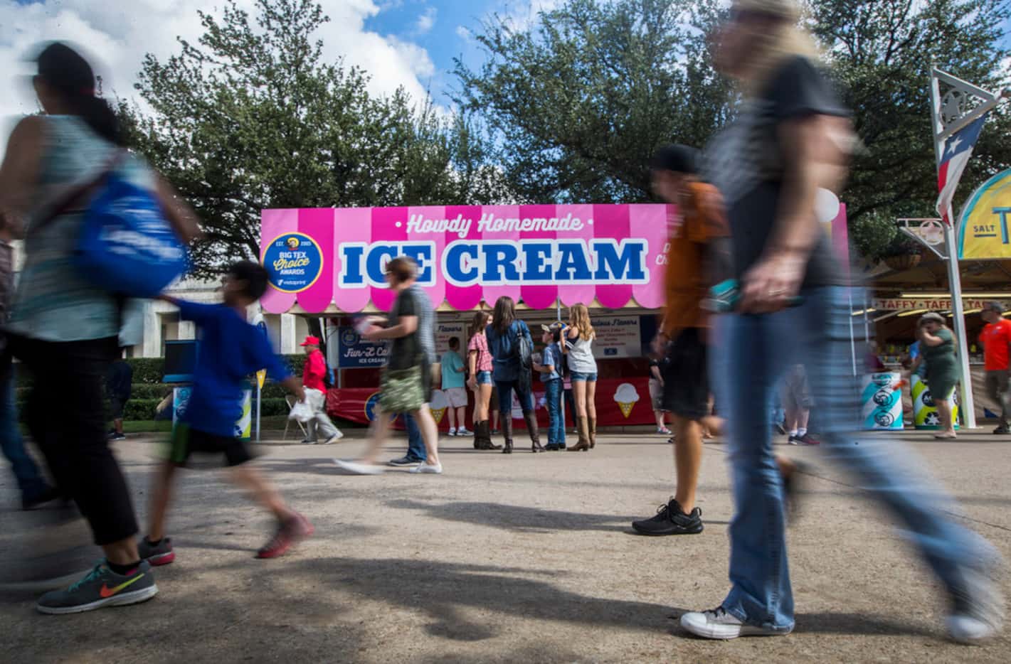 Fairgoers walk past Howdy Homemade Ice Cream at the State Fair of Texas in Dallas on Sept. 30.