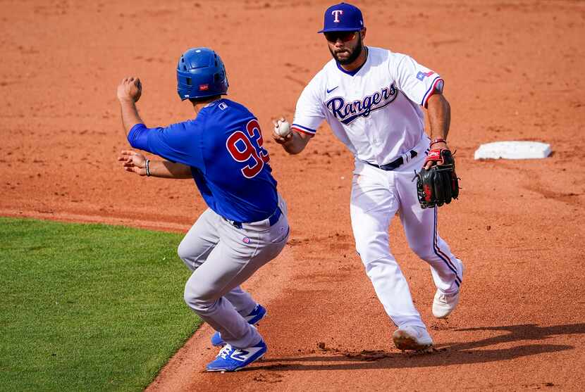 Texas Rangers shortstop Isiah Kiner-Falefa chases down the Chicago CubsÕ Alfonso Rivas to...
