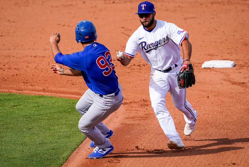 Texas Rangers shortstop Isiah Kiner-Falefa chases down the Chicago CubsÕ Alfonso Rivas to...