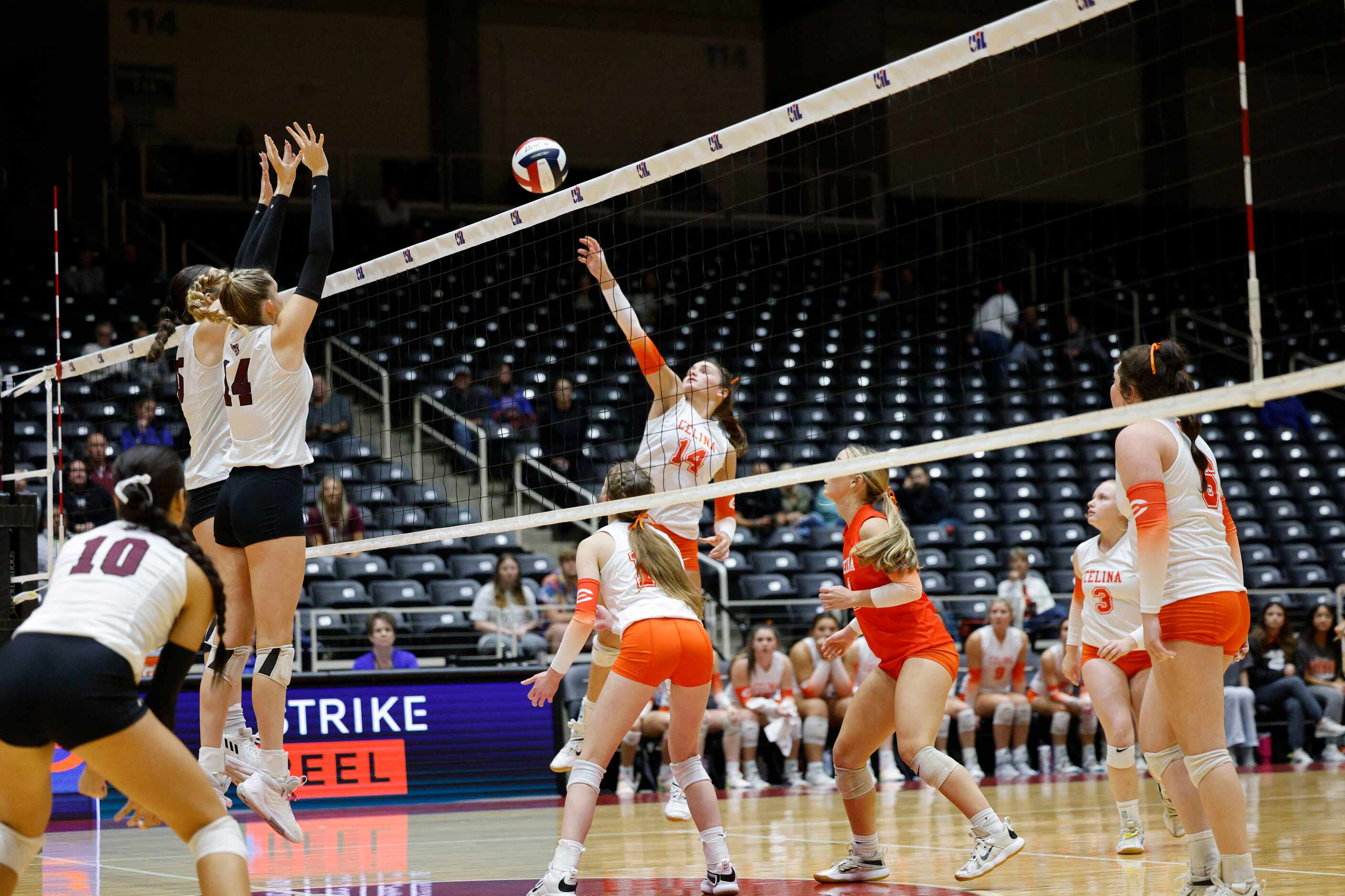 Celina's Kennedy Hangartner (14) spikes the ball during a UIL class 4A volleyball state...