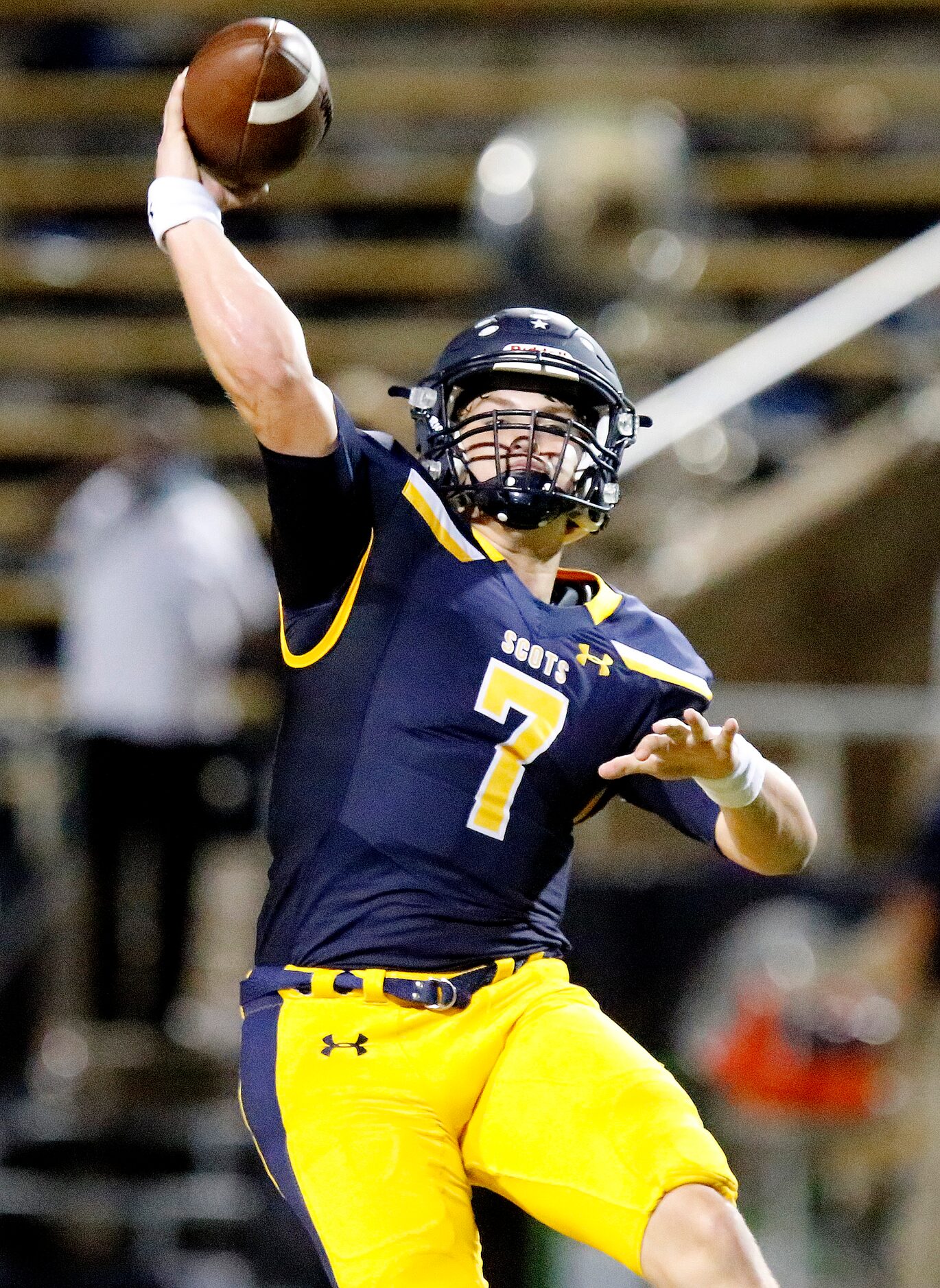 Highland Park High School quarterback Brennan Storer (7) throws a touchdown pass during the...