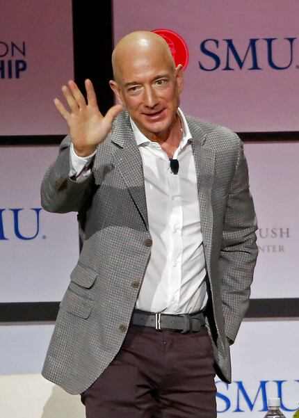 Jeff Bezos, chairman and CEO of Amazon, waved to the crowd after he spoke during a Closing...