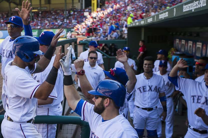 Texas Rangers second baseman Rougned Odor celebrates on his way back to the dugout after...