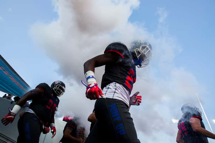 Southern Methodist Mustangs players enter the field before a game between Arkansas State and...