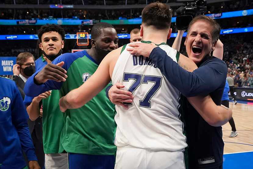 Dallas Mavericks guard Luka Doncic (77) celebrates with owner Mark Cuban after hitting a...