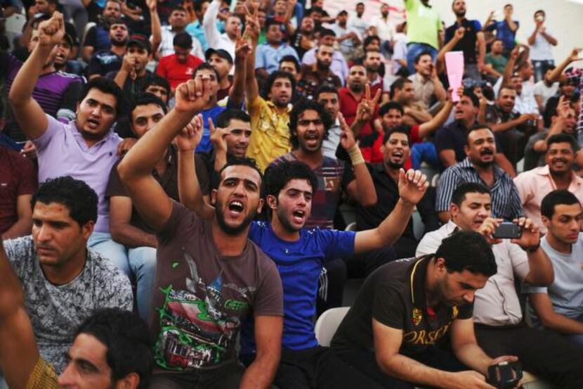 
Volunteers chant Shiite slogans at a security forces recruitment drive at a Baghdad...