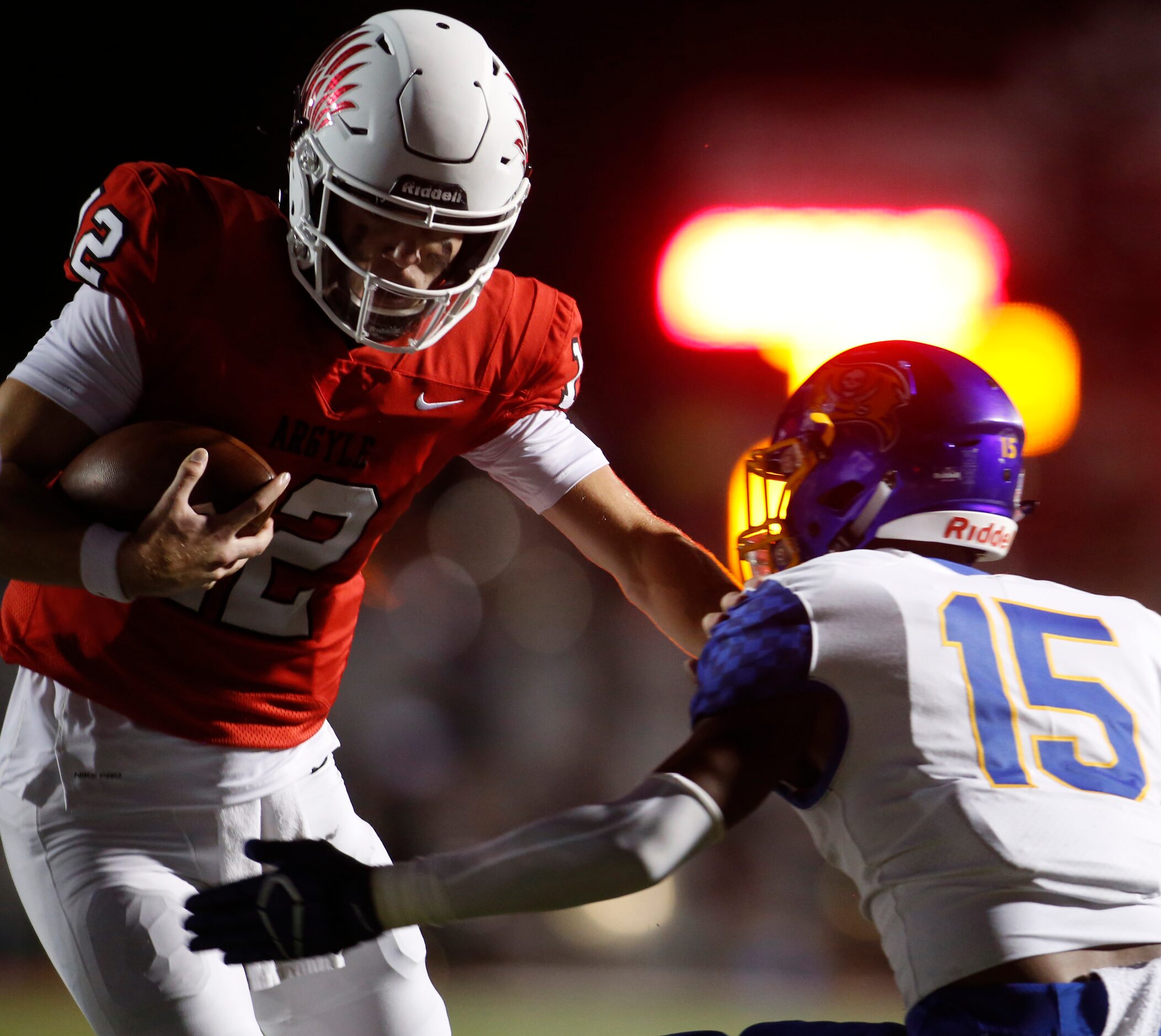 Argyle quarterback CJ Rogers (12) cuts inside to avoid the defensive pursuit of Waco La Vega...