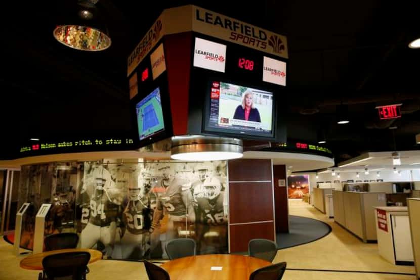 
Learfield’s company headquarters resembles a small arena with a circular mural of football...