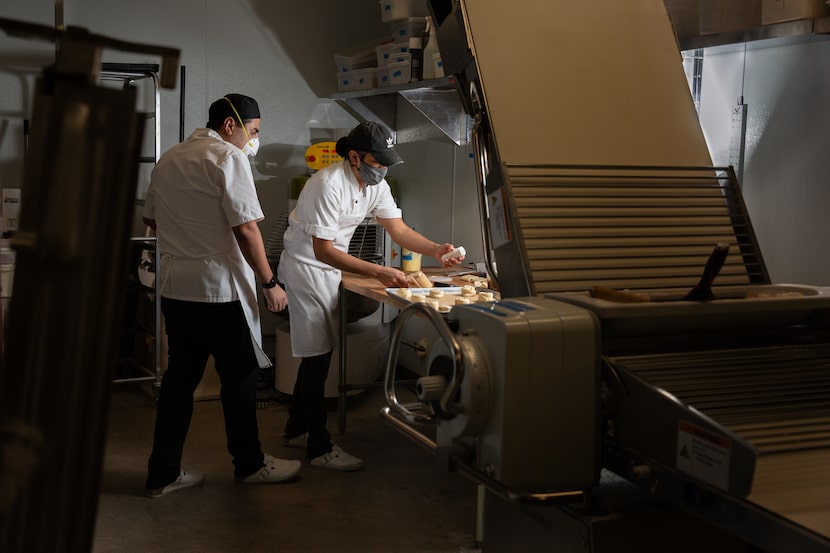 Head baker David Madrid watches and assists as Yonathan Bustillo prepares pastries at The...