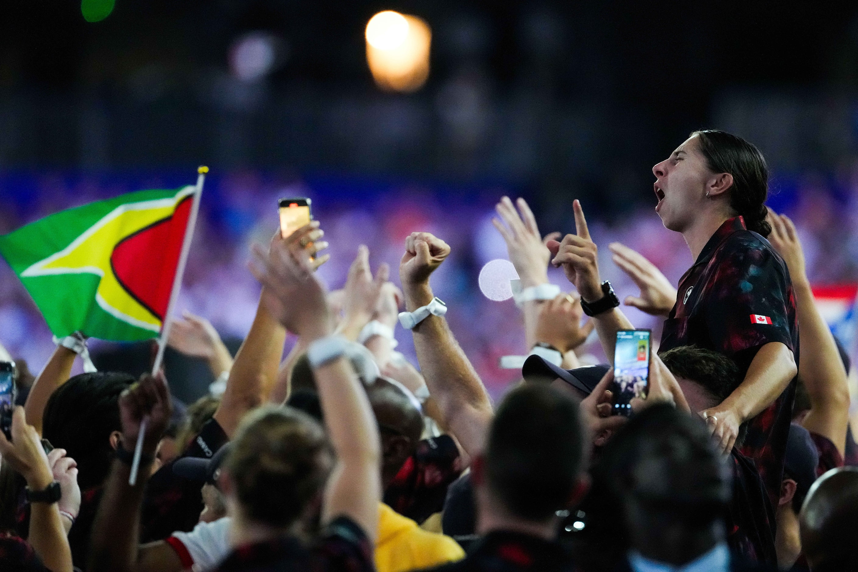 A Canadian athlete dances atop a teammates shoulders during closing ceremonies for the 2024...