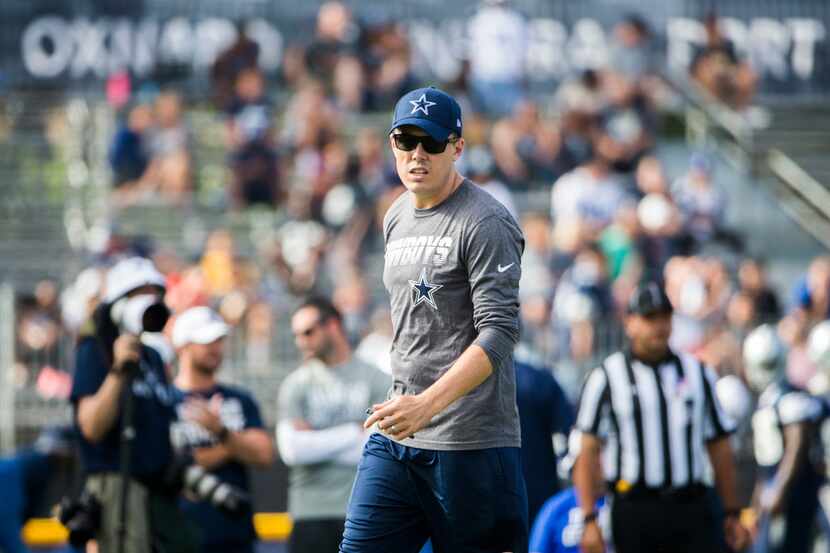 Dallas Cowboys offensive coordinator Kellen Moore watches a play during an afternoon...