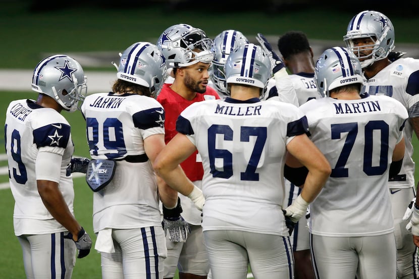 Dallas Cowboys quarterback Dak Prescott (4) talks in the huddle before a play during...