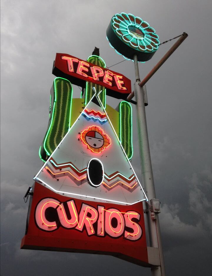 This  image shows the Tepee Curios neon sign along historic Route 66 as a storm approaches...