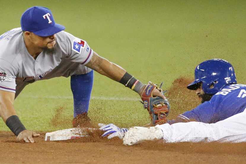 Texas Rangers second baseman Rougned Odor (12) tries to apply the tag to Toronto Blue Jays...