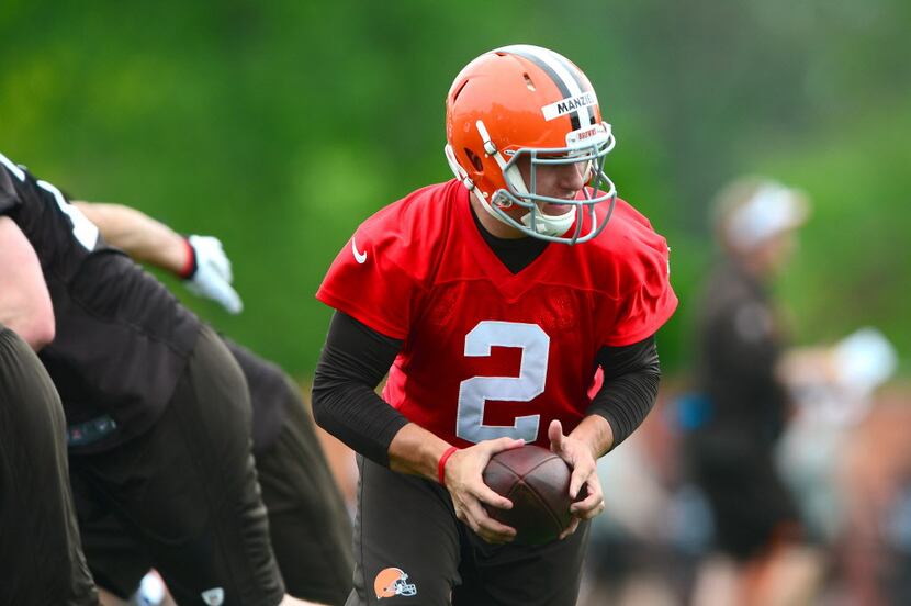 May 28, 2014; Berea, OH, USA; Cleveland Browns quarterback Johnny Manziel (2) hands the ball...