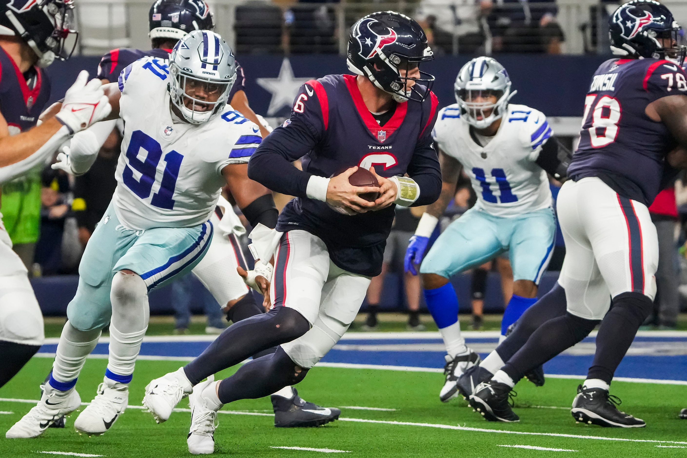 Houston Texans quarterback Jeff Driskel (6) scrambles away from Dallas Cowboys defensive end...