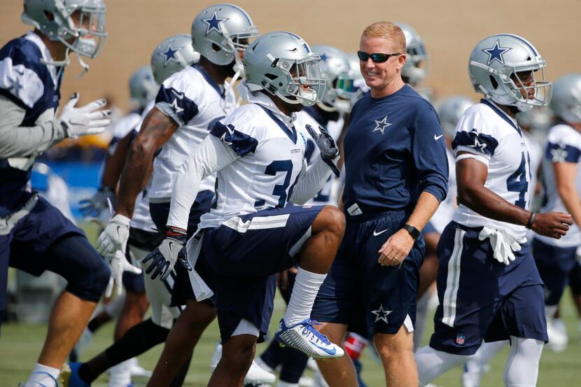 Dallas Cowboys head coach Jason Garrett looks at Dallas Cowboys running back Jahad Thomas...