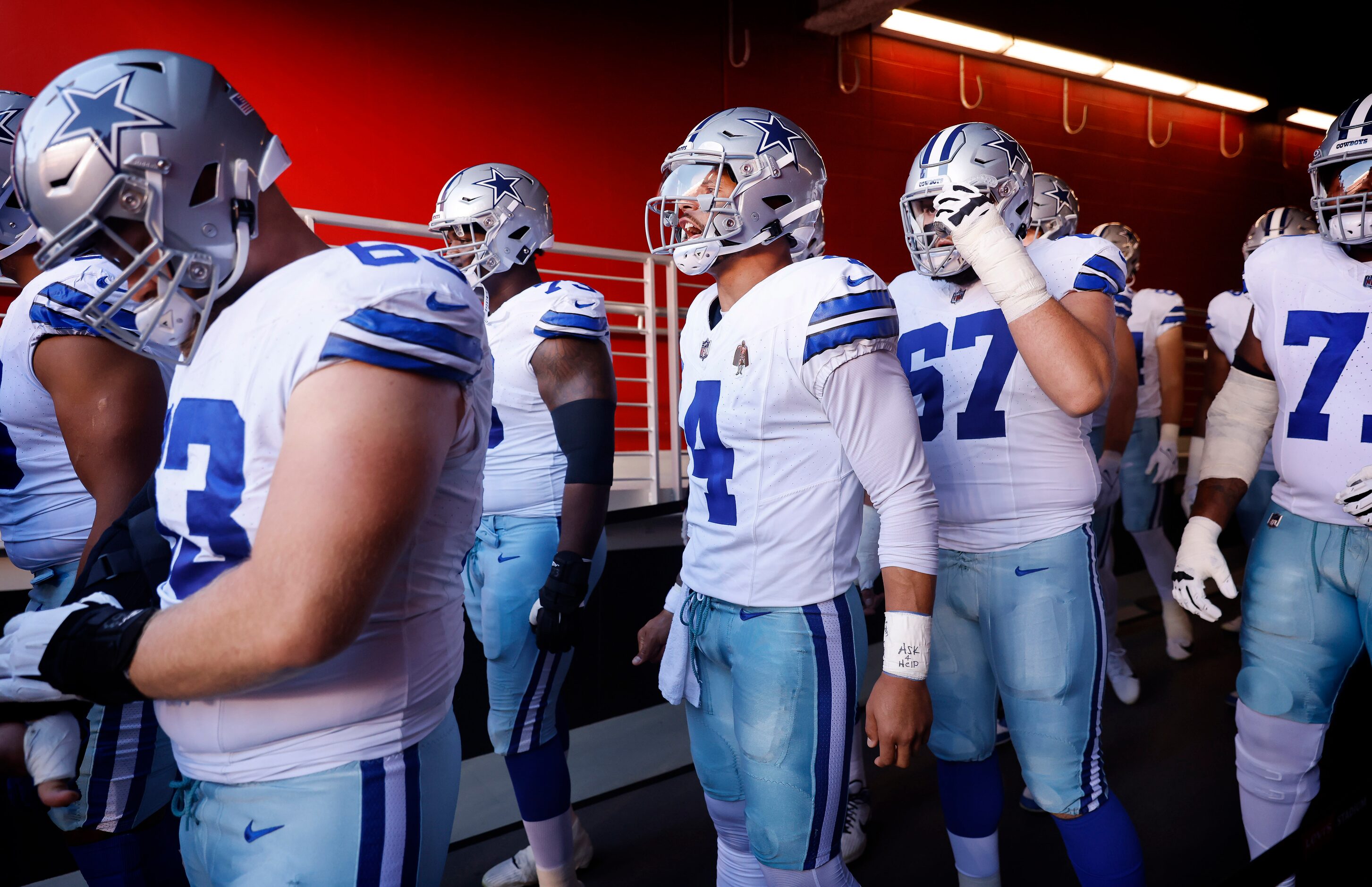 Dallas Cowboys quarterback Dak Prescott (4) gets his teammates fire up as they wait in the...