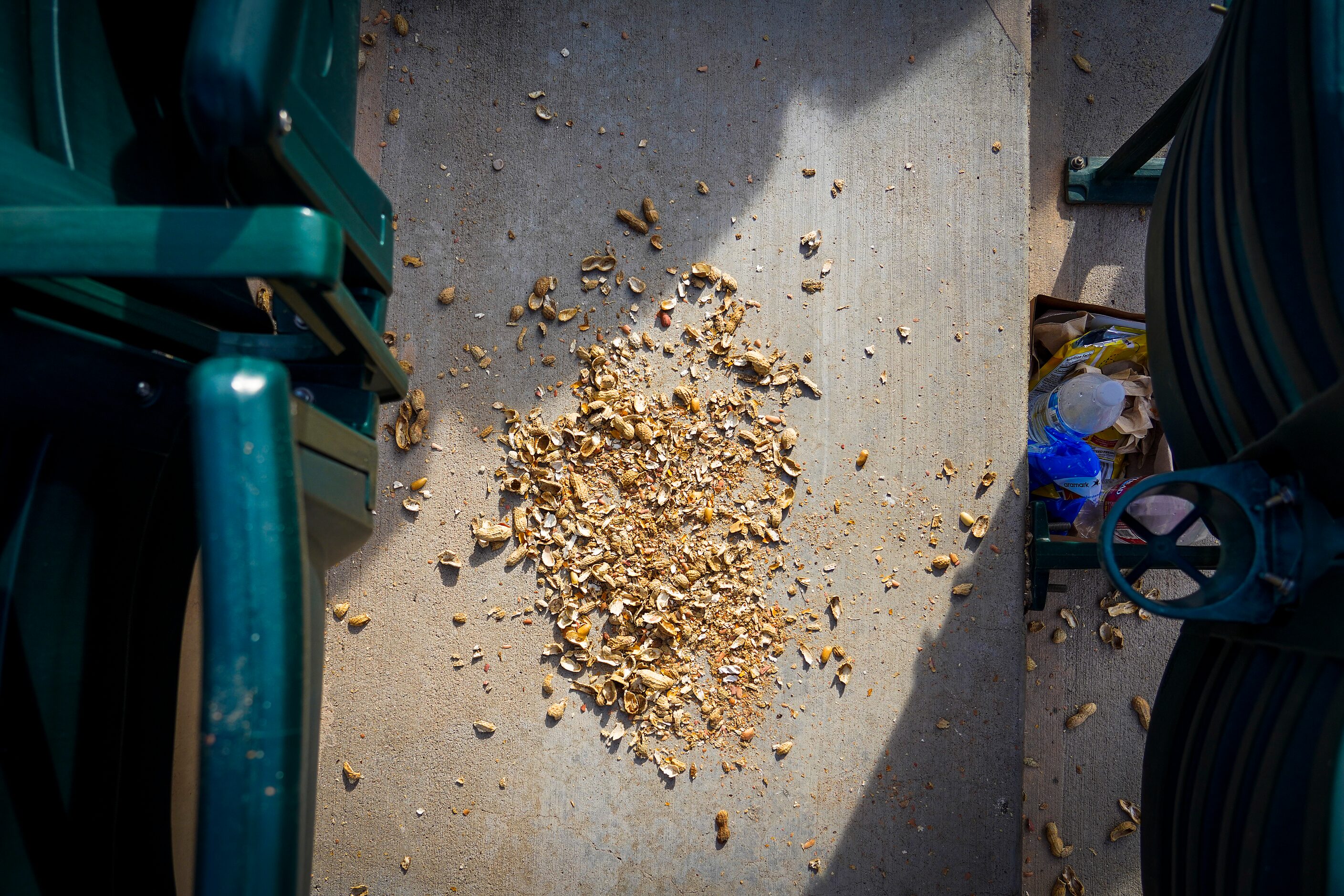 Peanut shells rest under stadium seats after the Texas Rangers 13-1 victory over the Chicago...