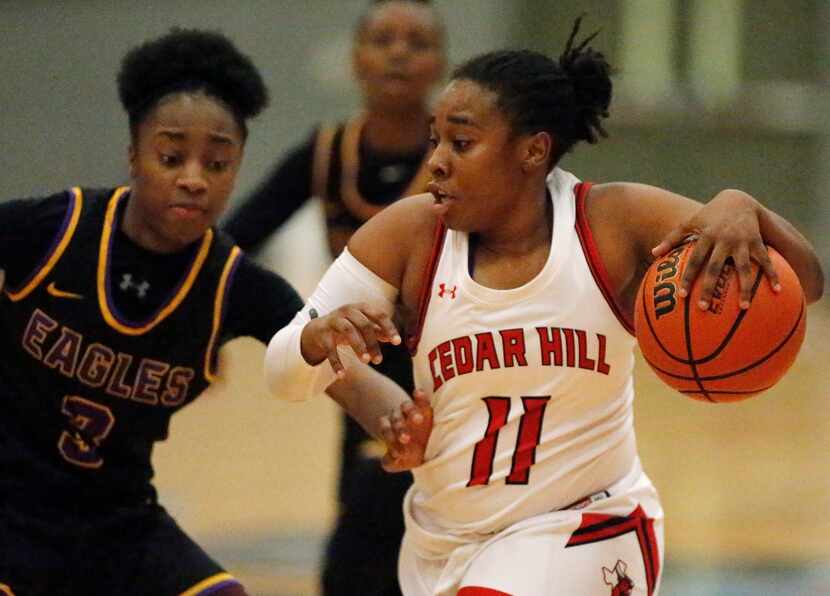 Cedar Hill High School guard Portia Adams (11) is defended by Richardson High School guard...