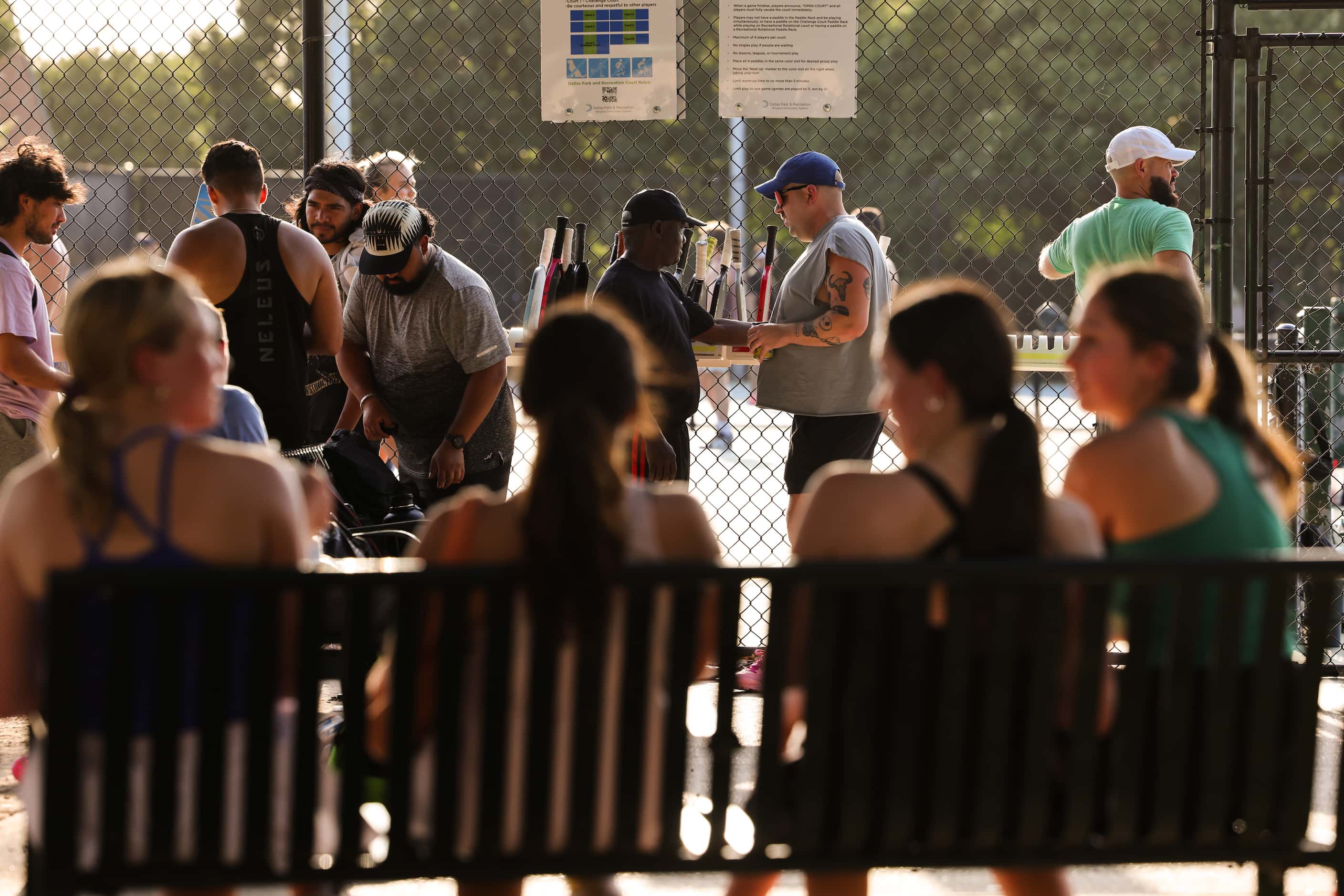Players wait for courts to play pickleball at Cole Park in Dallas.
