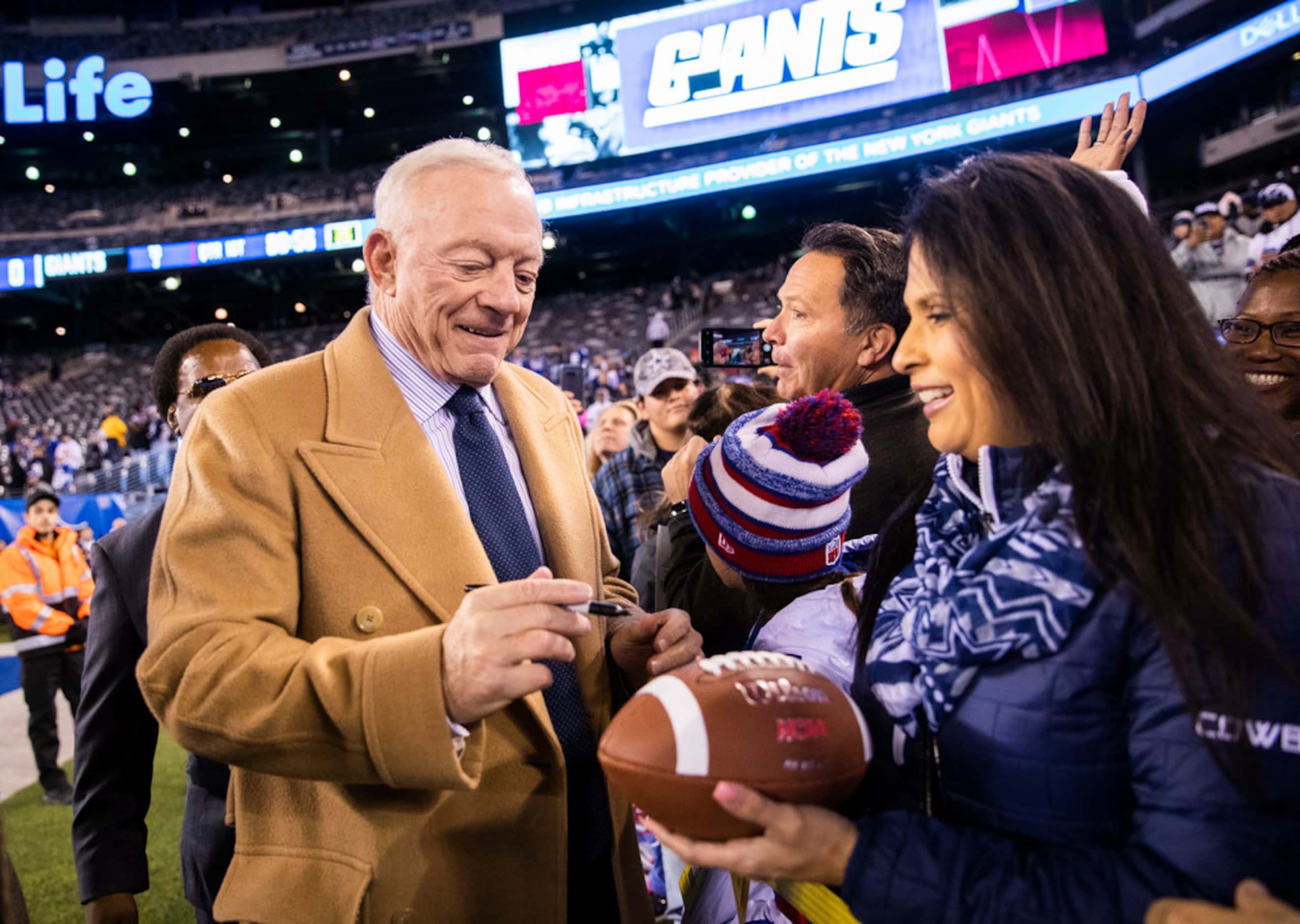 Dallas Cowboys Owner Jerry Jones signs autographs for fans before an NFL game between the...