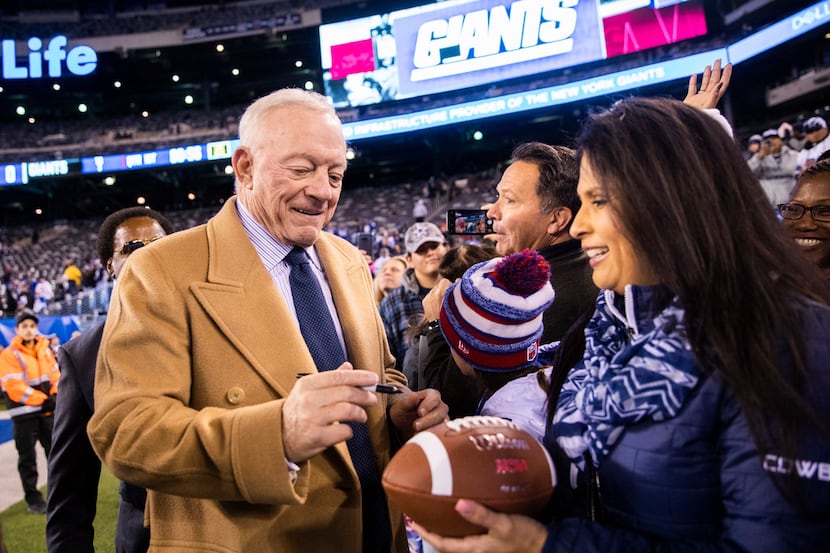 Dallas Cowboys Owner Jerry Jones signs autographs for fans before an NFL game between the...