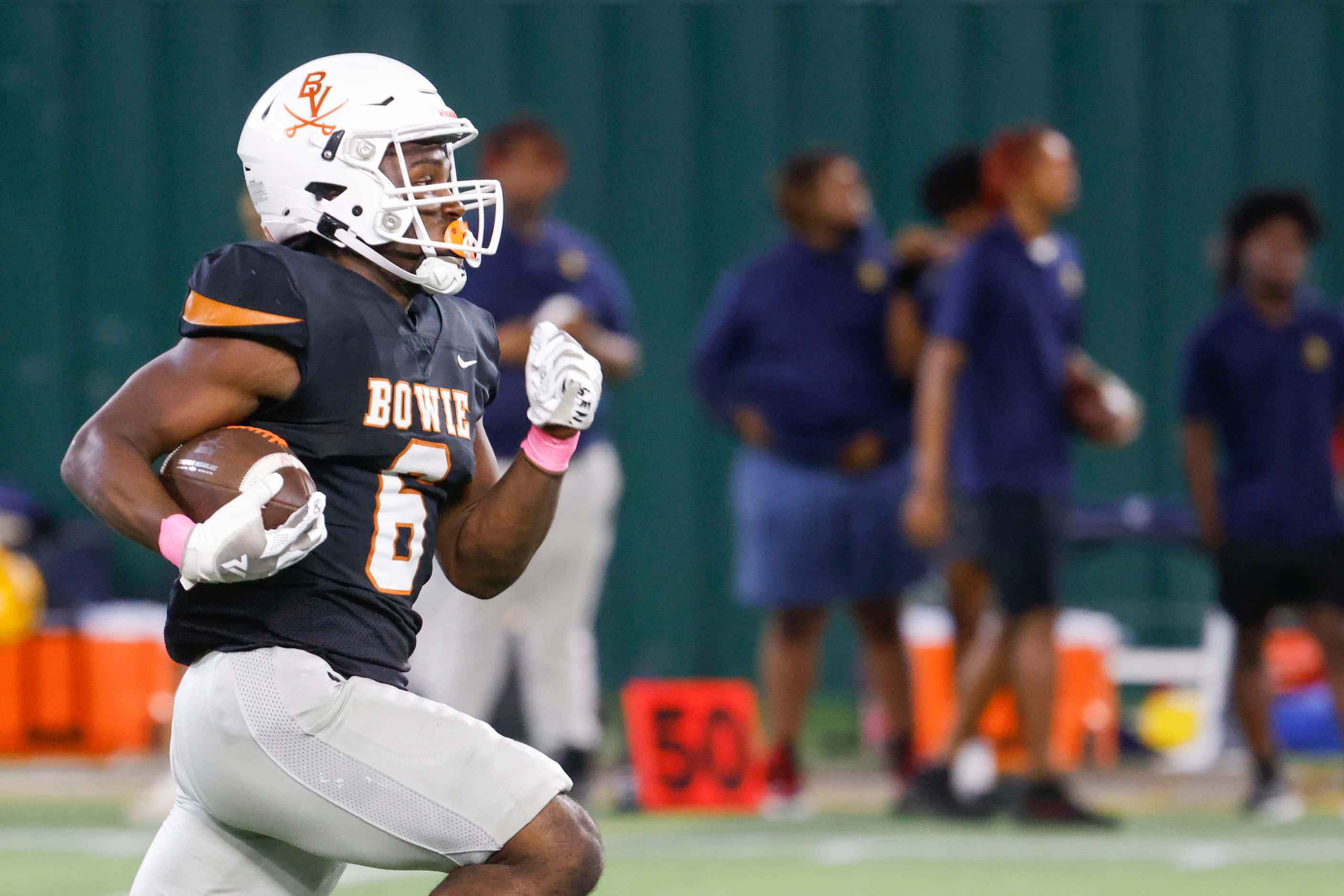 James Bowie High’s Darrion Bowers (front) runs for a touchdown during the first half of a...