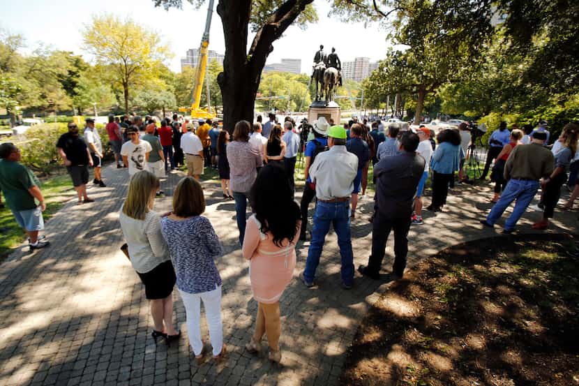People gathered all afternoon in the shade trees to witness the removal of the Robert E. Lee...