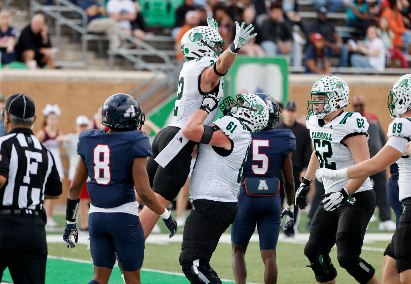 Southlake running back Owen Allen (2) is lifted by Walker Anderson (61) after scoring a...