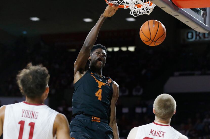 Texas forward Mohamed Bamba (4) dunks in front of Oklahoma guard Trae Young (11) and forward...